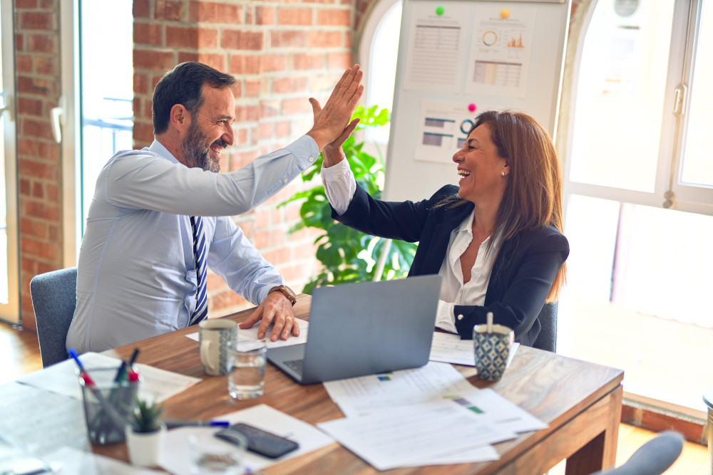 stock photo of man and woman high-fiving