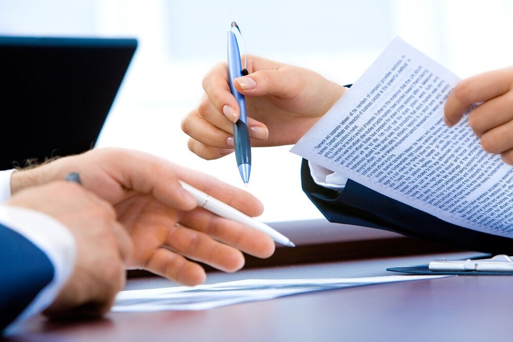 stock photo of hands signing papers