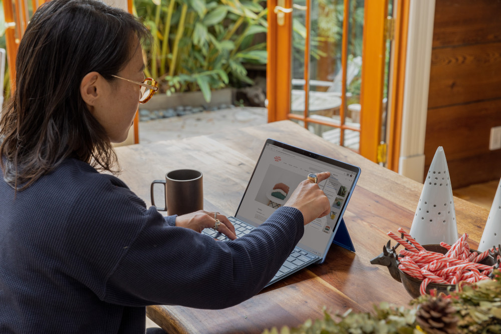 stock photo of person pointing to laptop