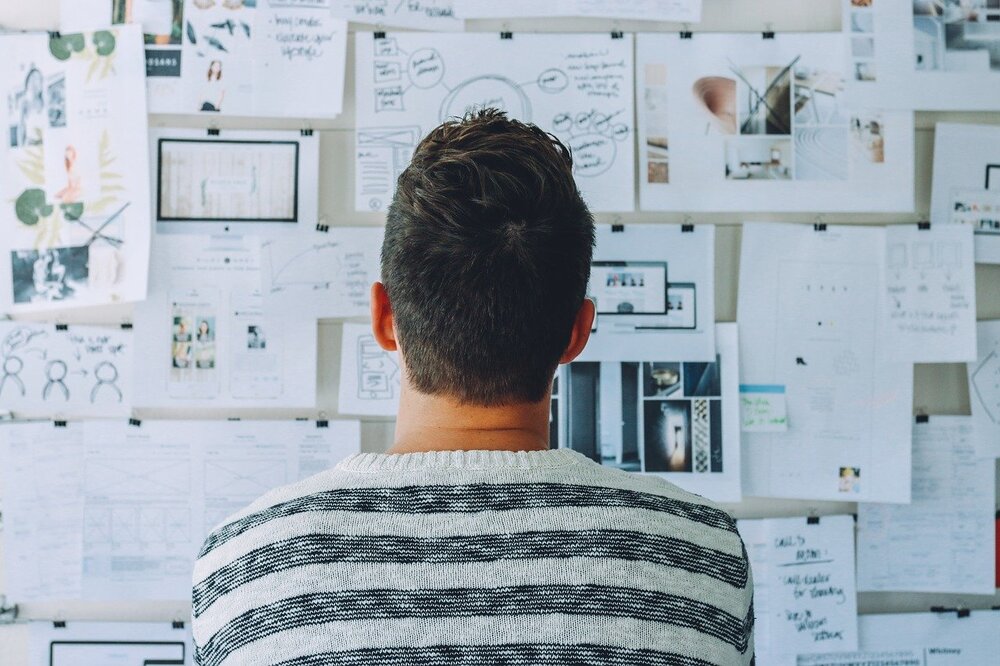 stock photo of man looking at bulletin board